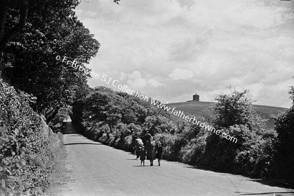 GROUP WALKING ALONG ROAD